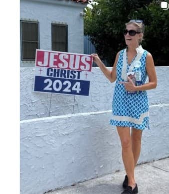 Victoria Doyle holding a campaign sign at a community event