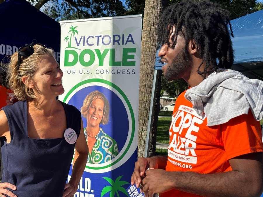 Victoria Doyle speaking with a community member at a campaign event