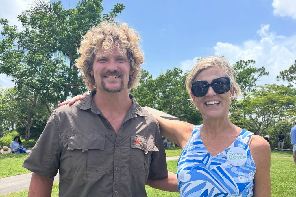 Victoria Doyle with a supporter at an outdoor community event in Palm Beach County